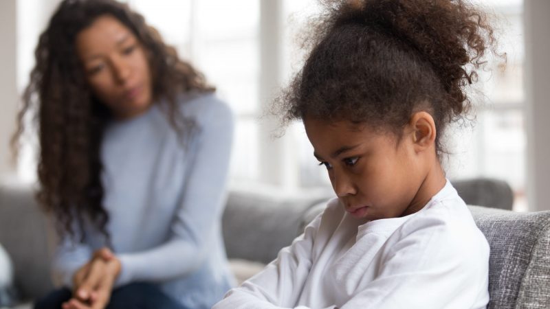 Mom or psychologist talking counseling upset offended african american child girl feels sad insulted, sulky frustrated black mixed race kid daughter having psychological trauma depression problem